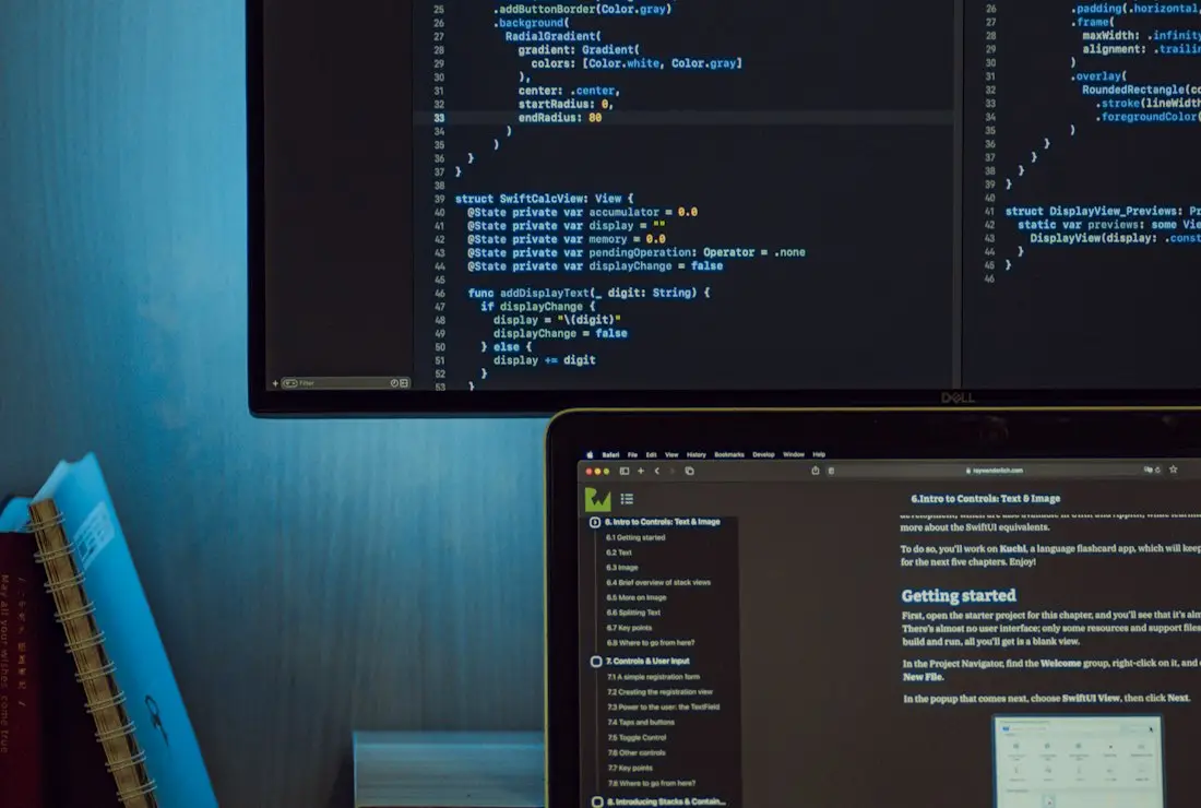 A monitor and laptop open on a build