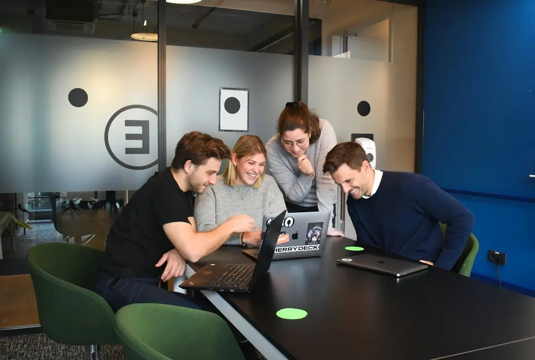 Colleagues working at laptops together
