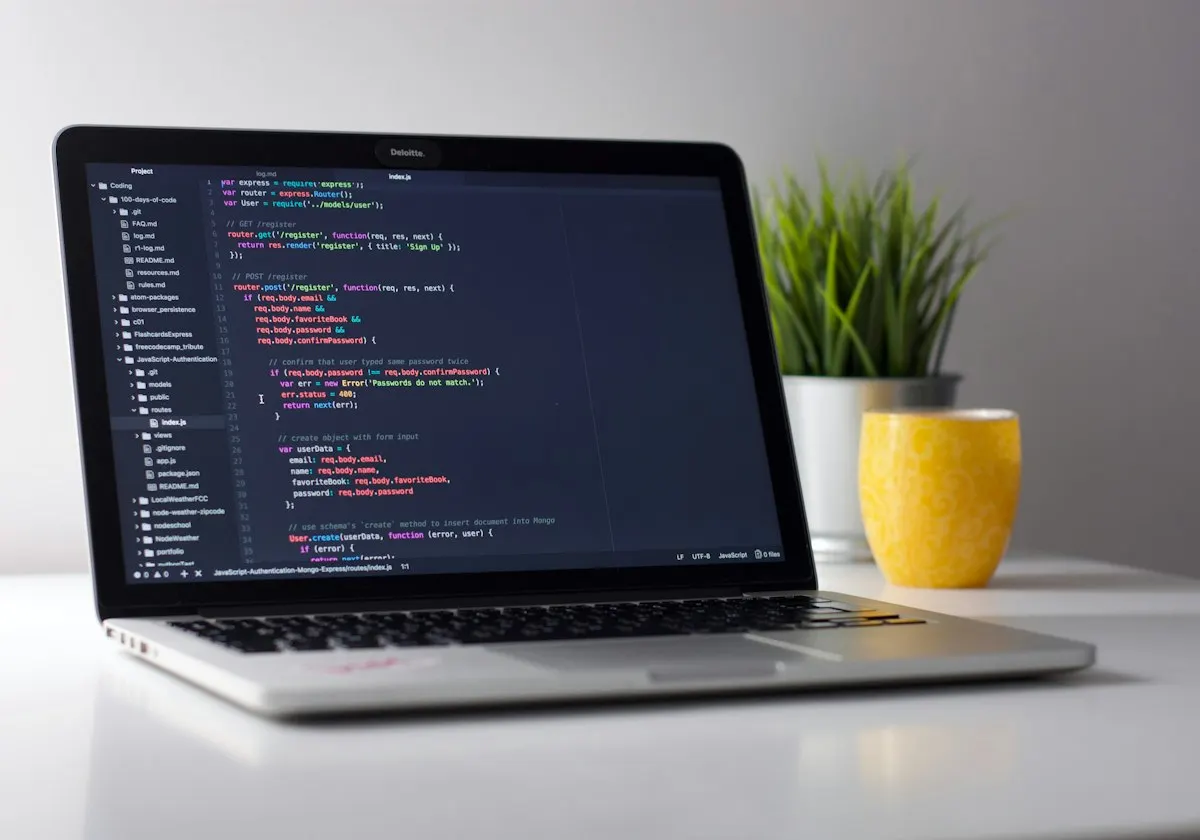 Web development code open on a laptop at a desk